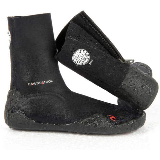 A pair of Ripcurl Dawn Patrol Isothermie 3mm Round Toe Boots in black neoprene with textured soles, side zips, and "DAWN PATROL" printed on the side, displayed against a white background.