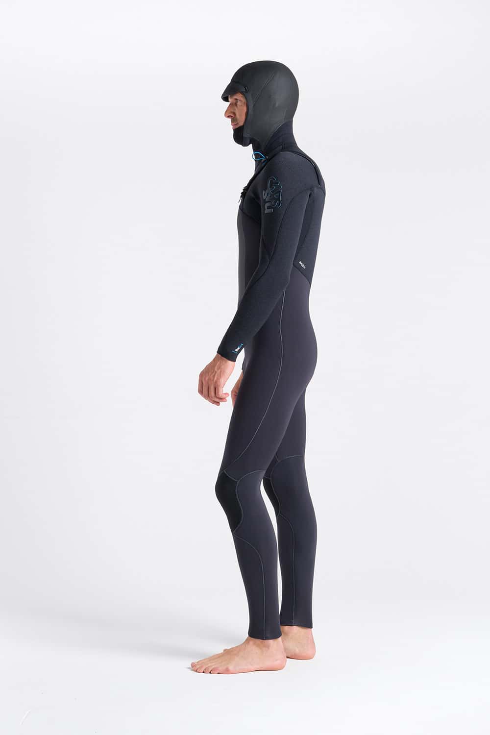 A man stands barefoot in profile against a plain white background, wearing the C-Skins Men's ReWired 5/4mm Hooded Wetsuit.