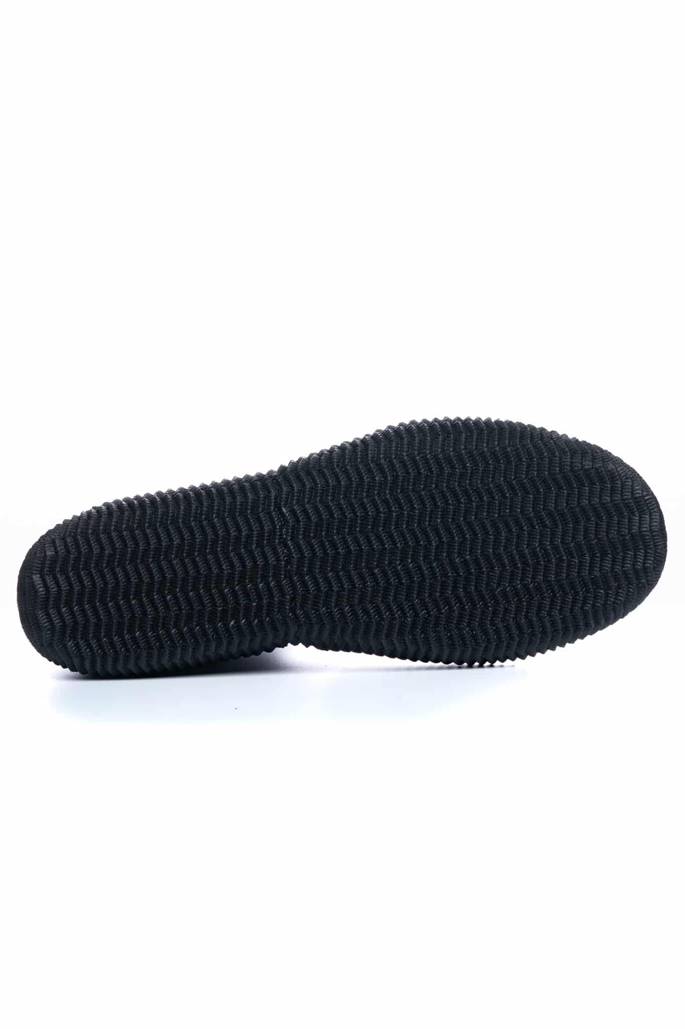 The C-Skins Adult Legend 5mm Zipped Round Toe Boots feature a black rubber sole with a textured, wavy tread pattern and rounded edges, photographed against a white background for a casual or athletic look.