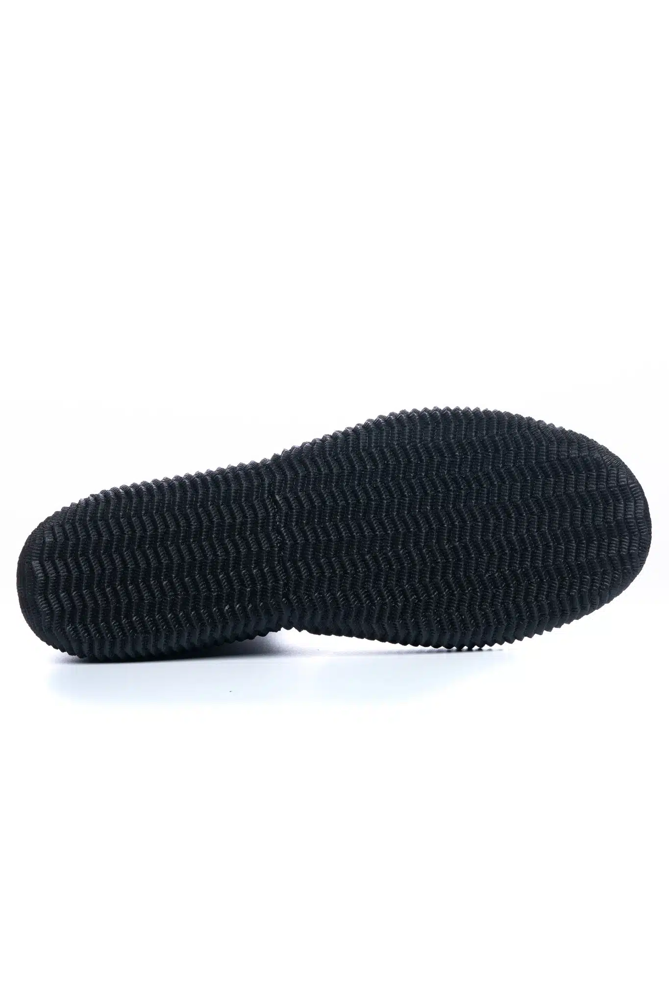 The C-Skins Adult Legend 5mm Zipped Round Toe Boots feature a black rubber sole with a textured, wavy tread pattern and rounded edges, photographed against a white background for a casual or athletic look.