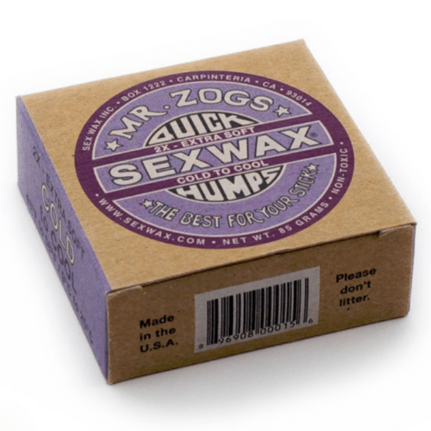 A box of Sex Wax Quick Humps Cold Water Surf Wax, labelled "2X Extra Soft" and "Cold to Cool," featuring purple and white graphics on brown cardboard. The package also says, "Please don't litter.