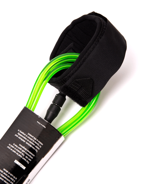 Close-up of the Surfboard Leash, featuring a green cord and black padded ankle strap, partially wrapped in packaging against a white background.