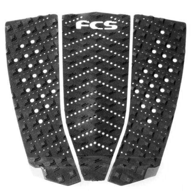 The FCS T-3W Wide Performance surfboard tail pad is a black, three-piece pad with diamond-textured grip, cut-out holes, and features a white "FCS" logo at the top centre for enhanced traction.
