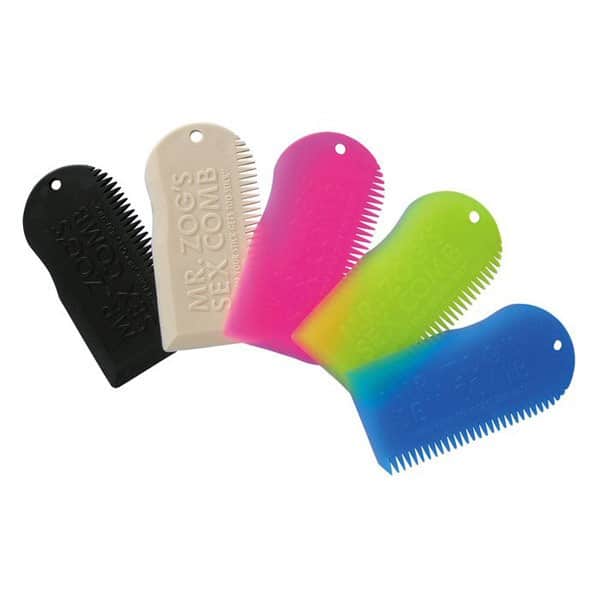Four plastic Sex Wax Surf Comb and Scraper combs in black, white, pink, and blue-green gradient, each with fine teeth and a corner hole, are arranged in a row. The combs display the “SEX WAX” logo.