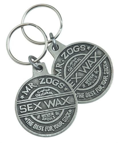 The Sex Wax Keyring is a metal medallion-shaped keyring with raised “Mr. Zogs Original Sex Wax - Never Spoils - The Best for Your Stick” text, attached to a key ring. Comes as a set of two.